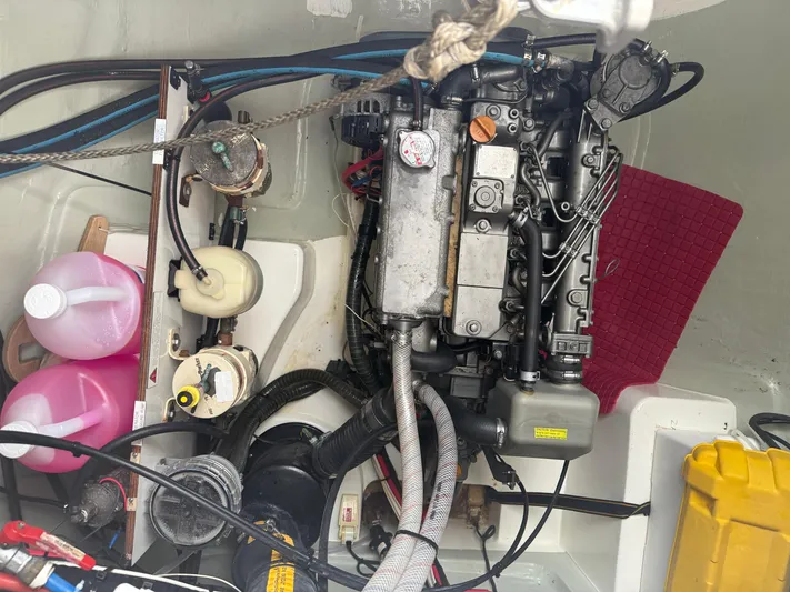 White Wings Yacht Photos Pics Engine compartment of a 2013 Leopard 48 yacht, featuring various mechanical components and fluid containers.