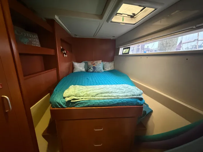 White Wings Yacht Photos Pics Cozy bedroom in 2013 Leopard 48 yacht with teal bedding and wooden cabinetry.