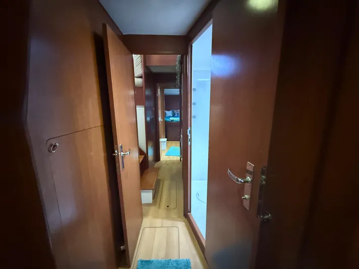 White Wings Yacht Photos Pics Interior hallway of 2013 Leopard 48 yacht with wooden doors and flooring.