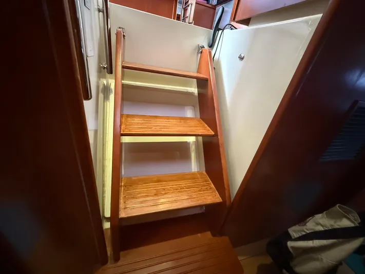 White Wings Yacht Photos Pics Wooden stairs inside a 2013 Leopard 48 yacht, leading to the cabin area.