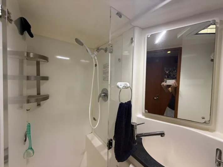 White Wings Yacht Photos Pics Bathroom interior of a 2013 Leopard 48 yacht with shower and sink.