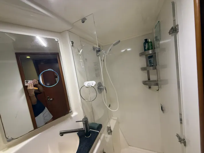 White Wings Yacht Photos Pics Bathroom interior of a 2013 Leopard 48 yacht with shower and sink.