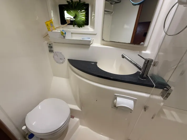 White Wings Yacht Photos Pics Bathroom in 2013 Leopard 48 yacht with modern sink, toilet, and window.