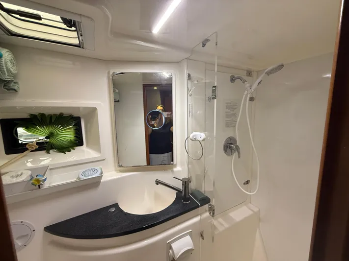 White Wings Yacht Photos Pics Luxurious bathroom in a 2013 Leopard 48 yacht with modern fixtures and shower.