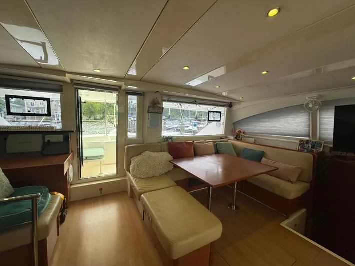 White Wings Yacht Photos Pics Luxurious interior of a 2013 Leopard 48 yacht with cozy seating and modern decor.