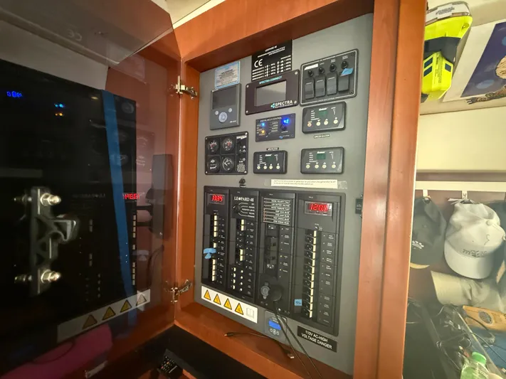 White Wings Yacht Photos Pics Electrical control panel inside a 2013 Leopard 48 yacht, featuring switches and meters.