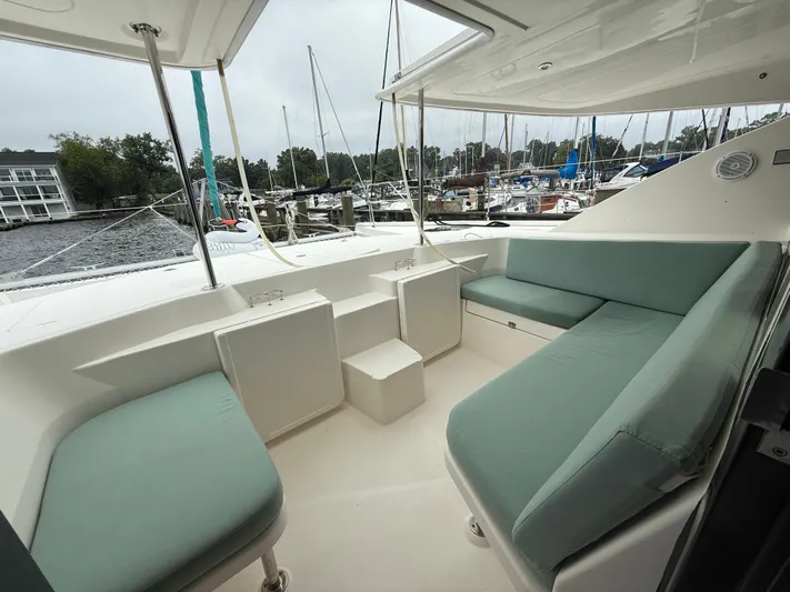 White Wings Yacht Photos Pics Leopard 48 yacht interior, 2013 model, featuring spacious seating and marina view.