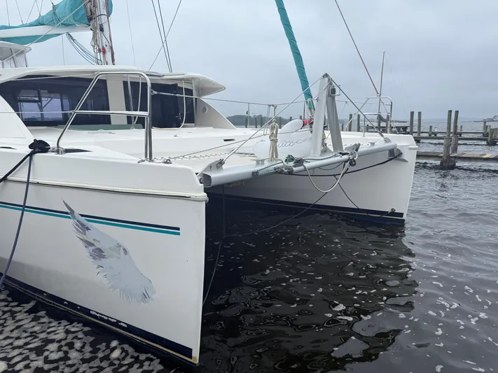 White Wings Yacht Photos Pics 2013 Leopard 48 catamaran docked at a marina on a cloudy day.
