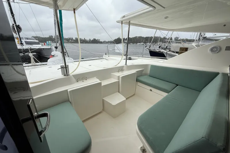 White Wings Yacht Photos Pics Spacious seating area on a 2013 Leopard 48 yacht, docked in a marina.