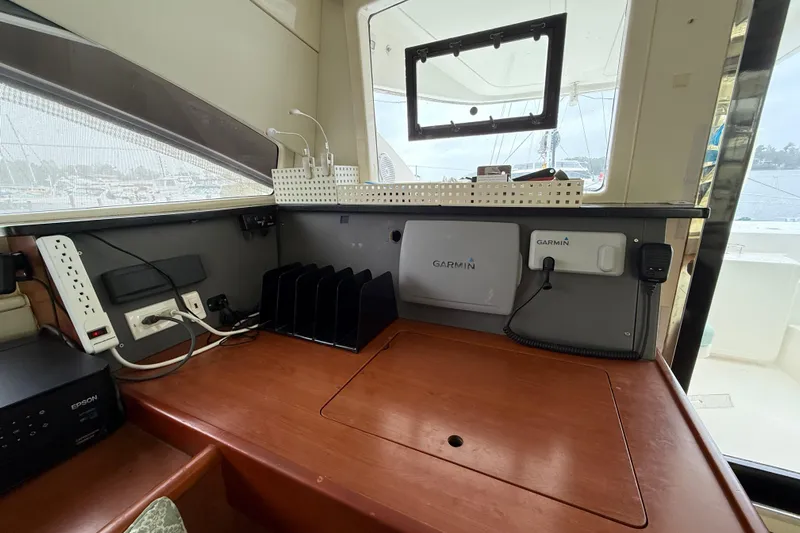 White Wings Yacht Photos Pics Interior of a 2013 Leopard 48 yacht with navigation equipment and organized workspace.