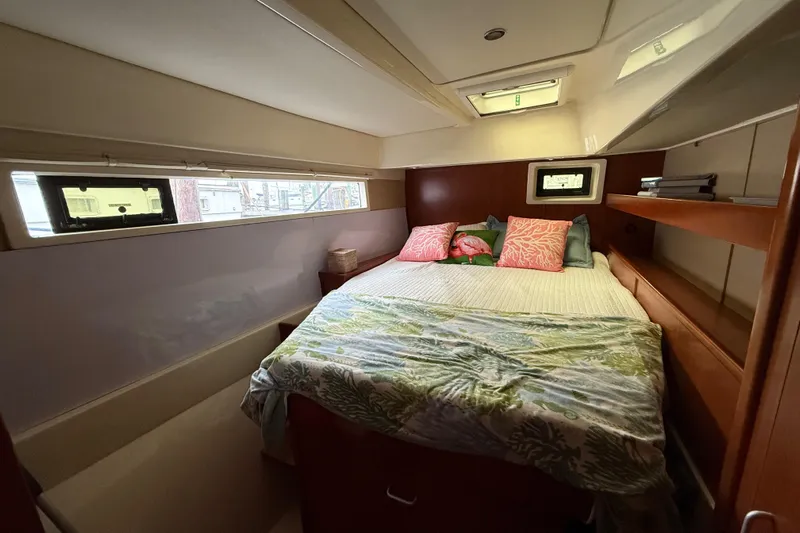 White Wings Yacht Photos Pics Cozy bedroom in 2013 Leopard 48 yacht with colorful pillows and natural light.