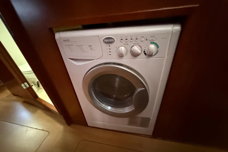 White Wings Yacht Photos Pics Compact washing machine in a 2013 Leopard 48 yacht interior.