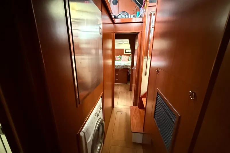 White Wings Yacht Photos Pics Interior of 2013 Leopard 48 yacht with wooden finishes and visible laundry area.