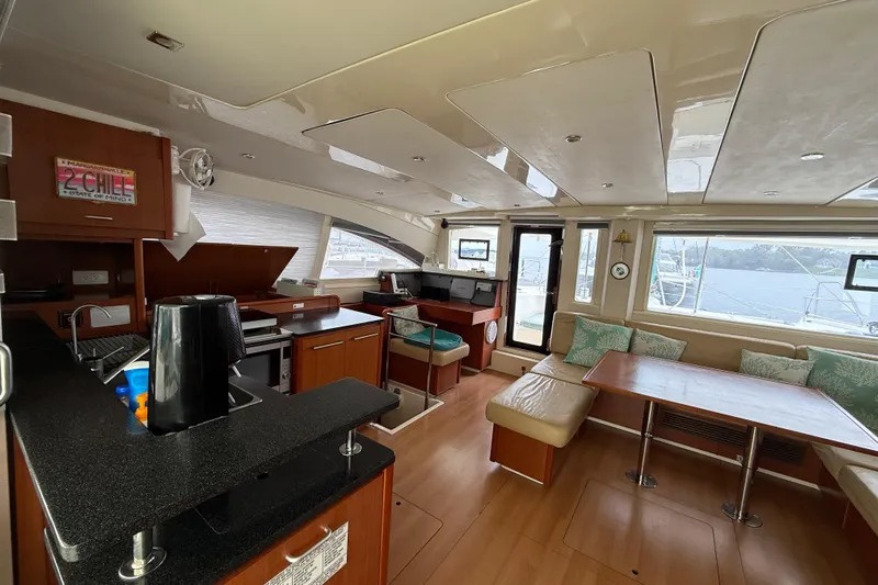 White Wings Yacht Photos Pics Luxurious 2013 Leopard 48 yacht interior with modern kitchen and spacious seating area.