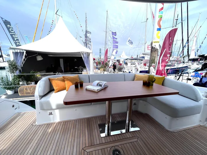  Yacht Photos Pics Luxurious 2023 Azimut Fly 53 yacht deck with seating and table at a boat show.