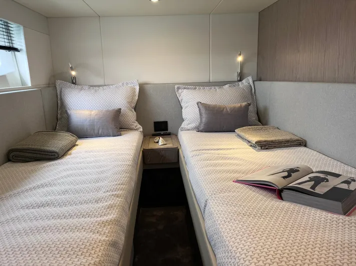  Yacht Photos Pics Luxurious twin cabin in 2023 Azimut Fly 53 yacht, featuring elegant bedding and modern decor.