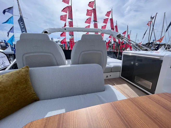 Yacht Photos Pics 2023 Azimut Fly 53 yacht interior with seating, table, and flags in the background.