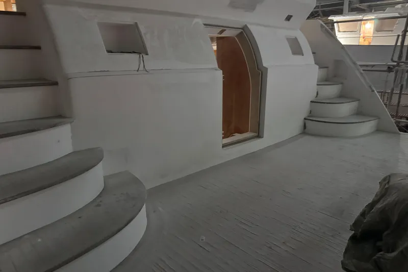 Opportunity Yacht Photos Pics Interior of 2026 Artemis 100 yacht with curved stairs and modern design.