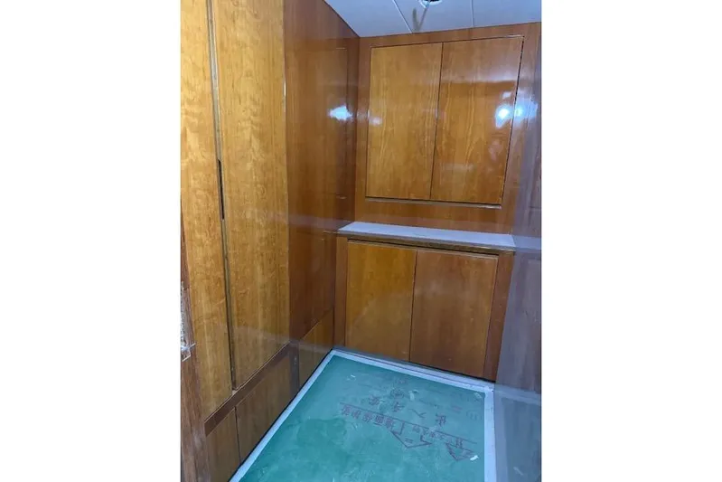 Opportunity Yacht Photos Pics Wood-paneled interior of Artemis 100, 2026 model, featuring sleek cabinetry design.