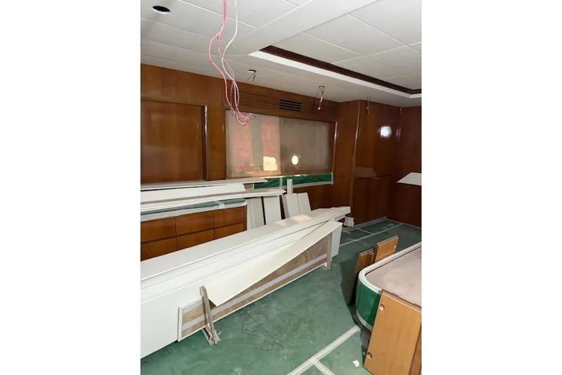 Opportunity Yacht Photos Pics Interior of Artemis 100 yacht, 2026 model, under renovation with wood paneling and green flooring.
