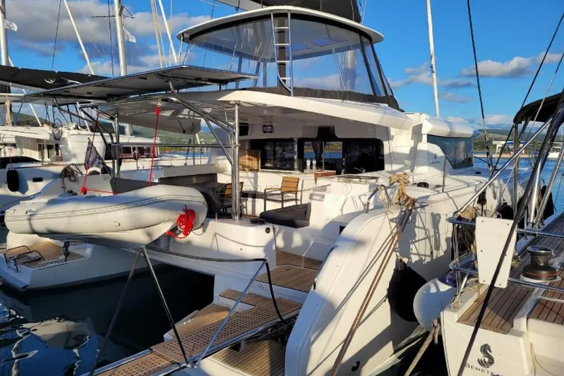  Yacht Photos Pics 2021 Lagoon 46 catamaran docked at marina, featuring spacious deck and modern design.