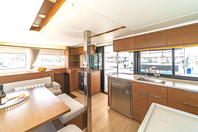  Yacht Photos Pics Luxurious interior of 2021 Lagoon 46 catamaran with modern kitchen and dining area.
