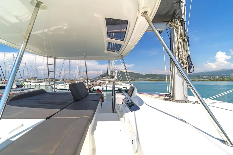  Yacht Photos Pics Lagoon 46 catamaran, 2021 model, docked in a scenic marina with clear skies.