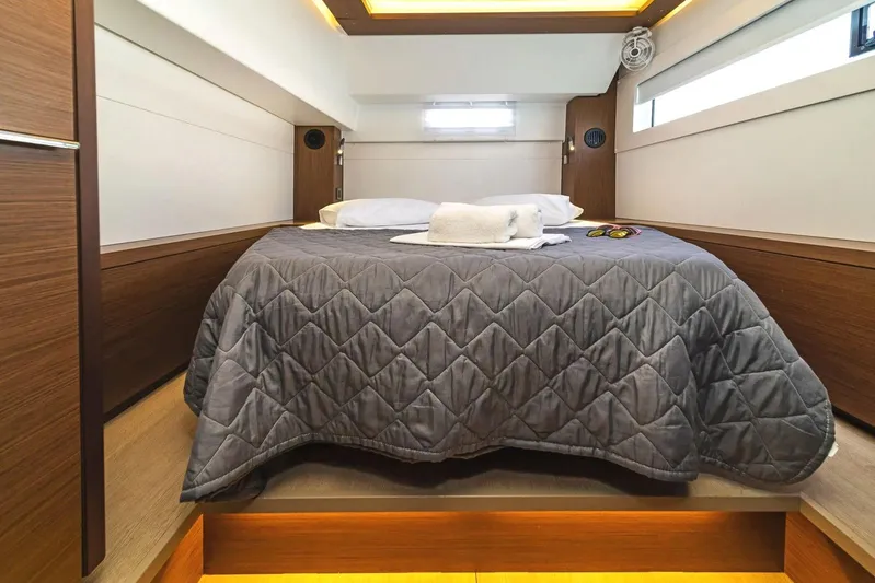  Yacht Photos Pics Luxurious cabin interior of 2021 Lagoon 46 yacht with cozy bedding and modern design.