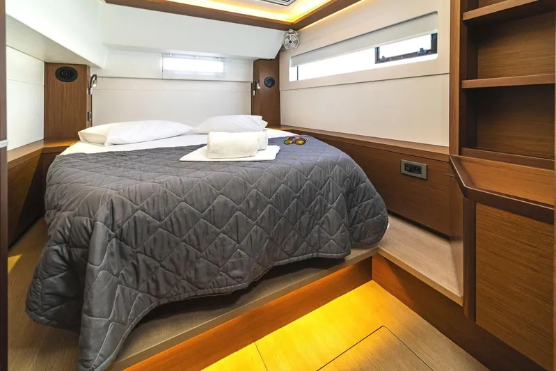  Yacht Photos Pics Luxurious cabin interior of 2021 Lagoon 46 yacht with cozy bed and modern design.