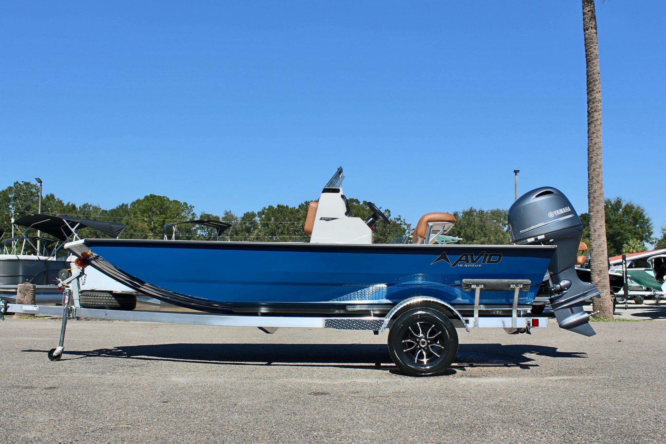 2025 Avid 18 Rogue CC boat on trailer, blue exterior, parked outdoors.