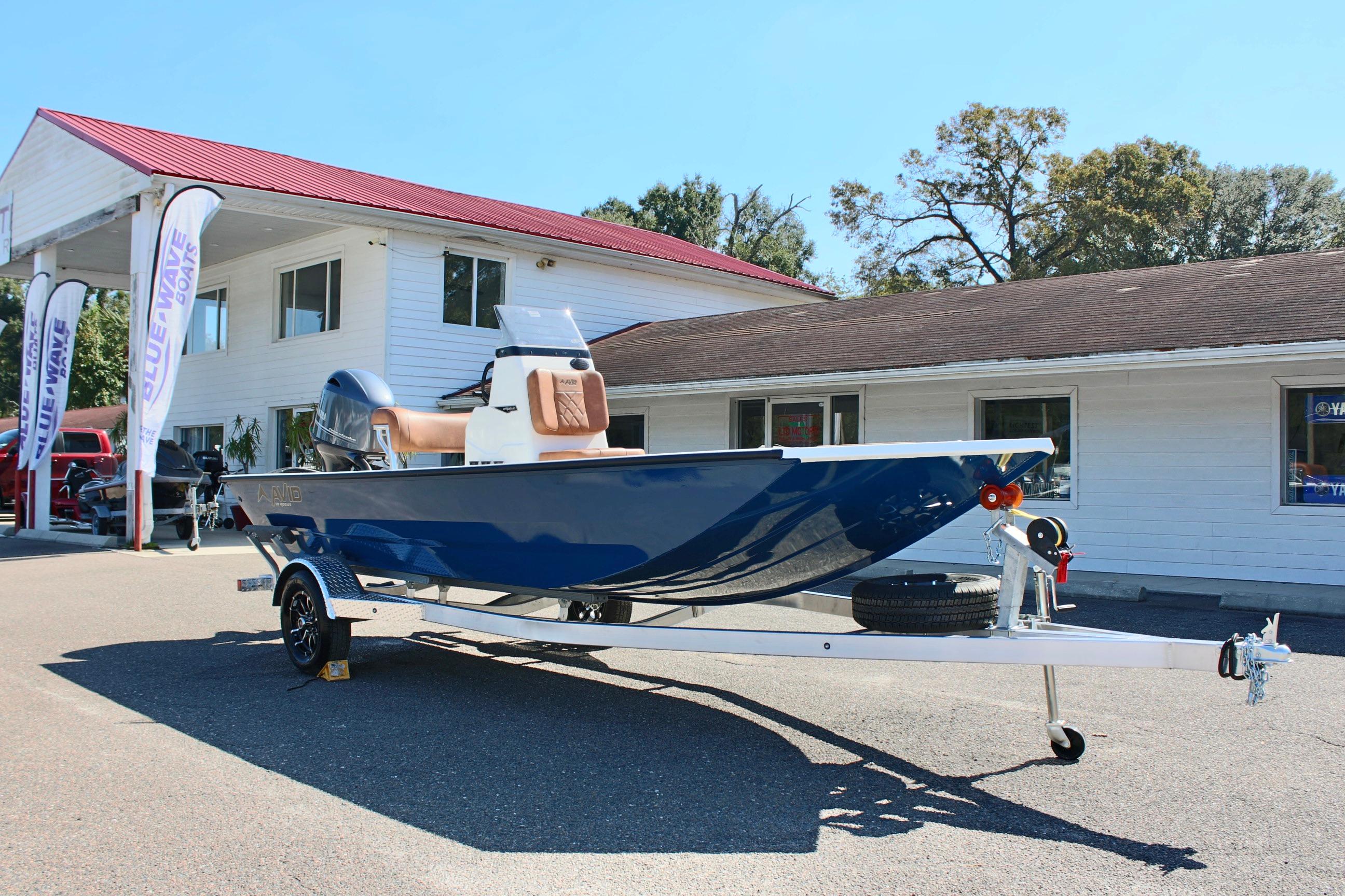 2025 Avid 18 Rogue CC boat on trailer outside dealership.
