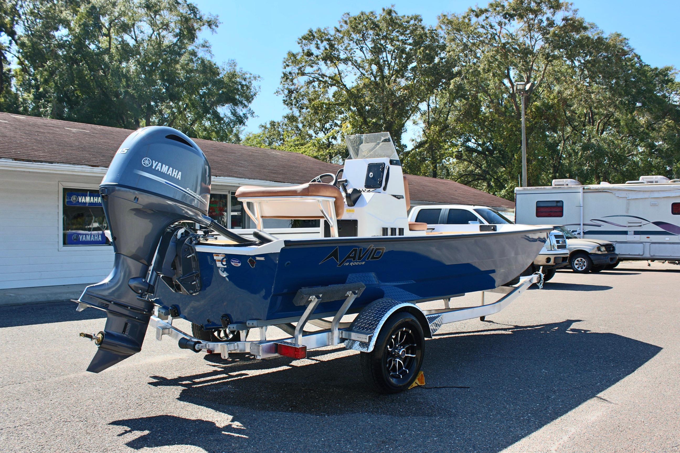2025 Avid 18 Rogue CC boat with Yamaha motor in parking lot.