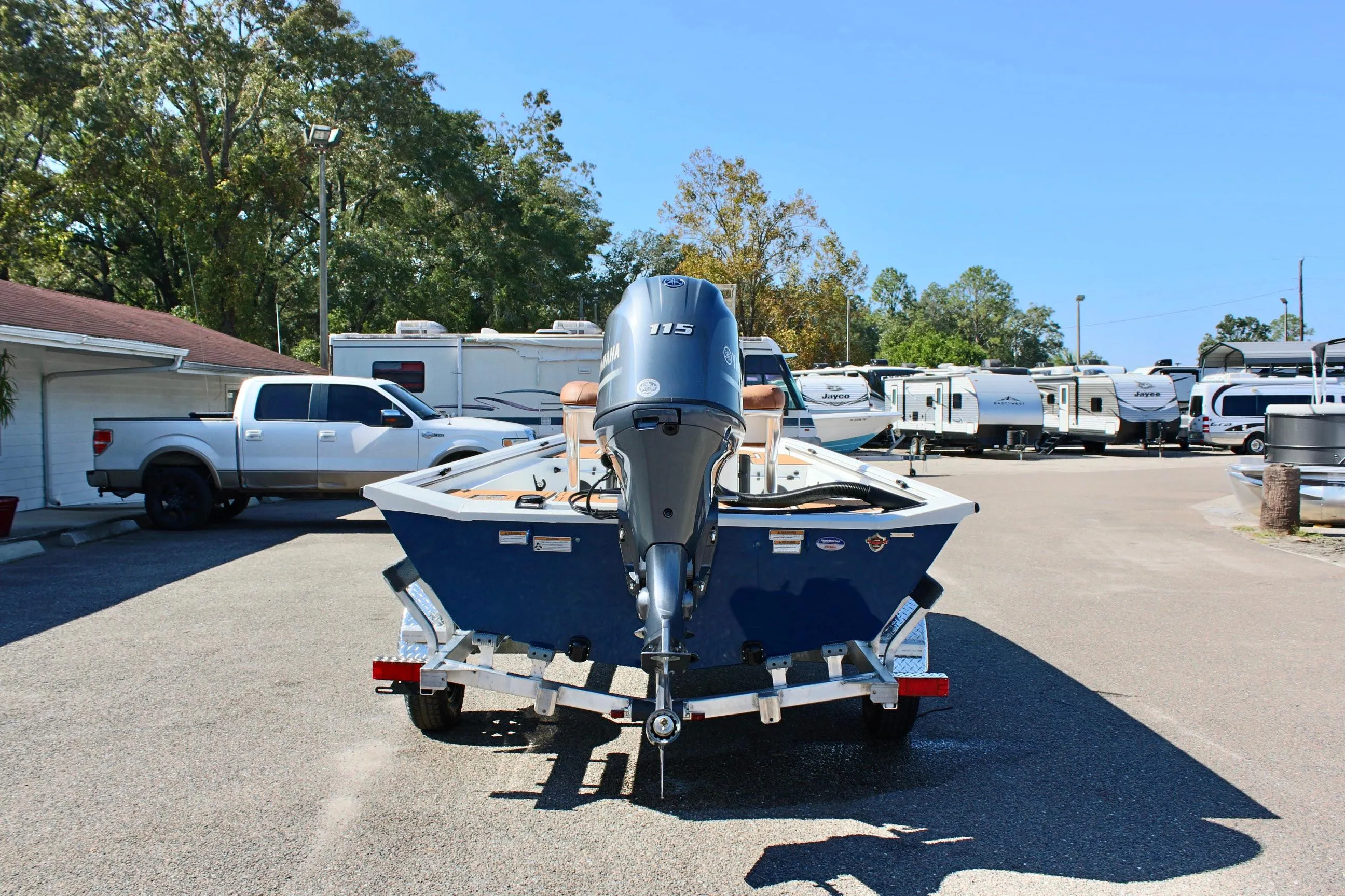 Avid 18 Rogue CC 2025 boat on trailer in parking lot.