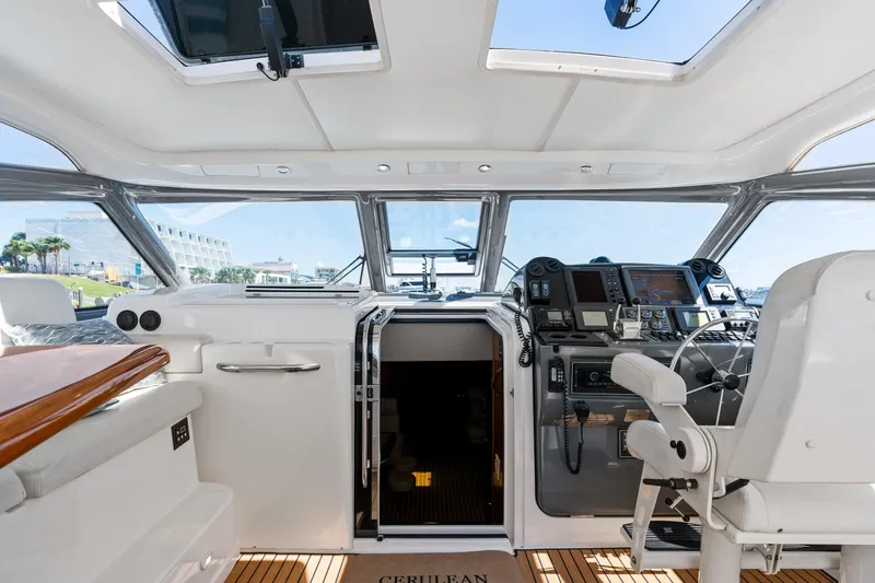 Cerulean Yacht Photos Pics 2000 Tiara Yachts 52 Express Cruiser cockpit with helm, seating, and navigation equipment.