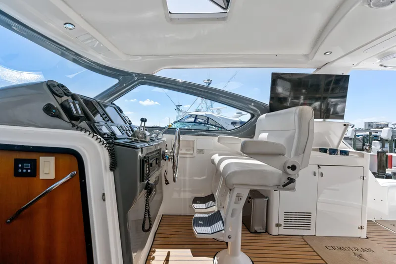 Cerulean Yacht Photos Pics Interior helm of 2000 Tiara Yachts 52 Express Cruiser with modern controls and seating.