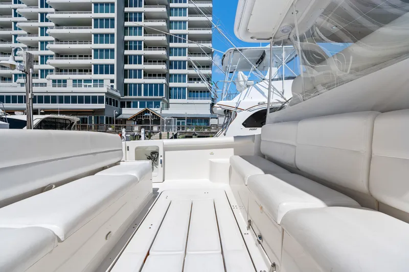 Cerulean Yacht Photos Pics 2000 Tiara Yachts 52 Express Cruiser with white seating, docked near modern buildings.