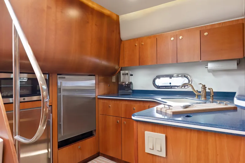 Cerulean Yacht Photos Pics Interior of 2000 Tiara Yachts 52 Express Cruiser, featuring a modern kitchen with wood cabinetry.