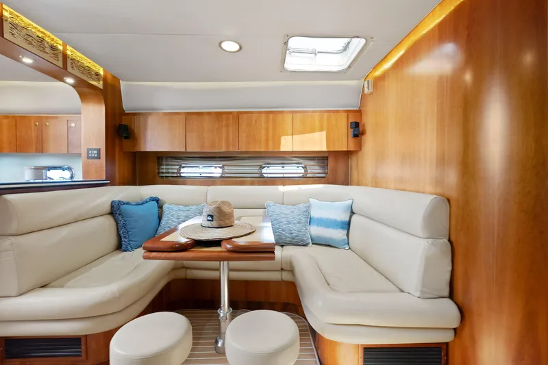 Cerulean Yacht Photos Pics Interior of 2000 Tiara Yachts 52 Express Cruiser with plush seating and wooden accents.