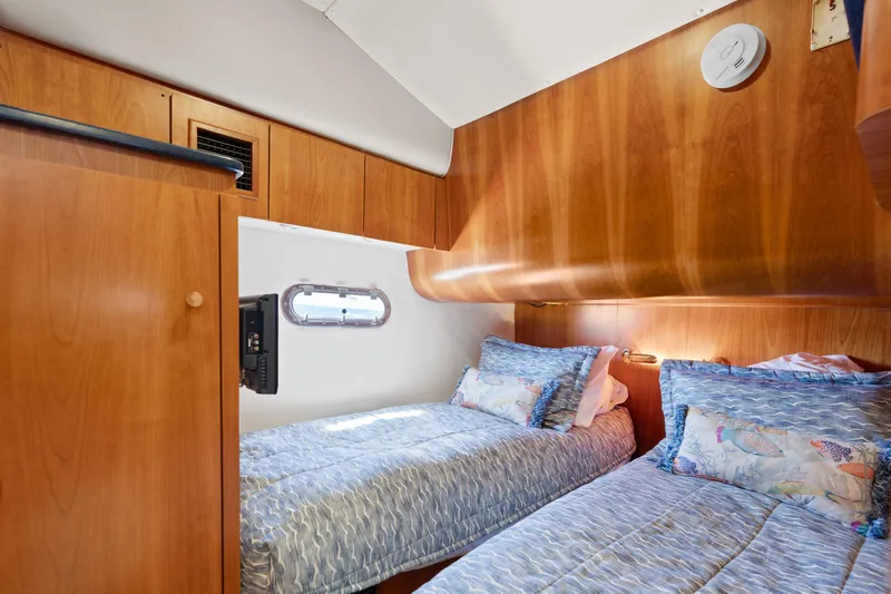 Cerulean Yacht Photos Pics Cabin interior of 2000 Tiara Yachts 52 Express Cruiser with twin beds and wooden finish.