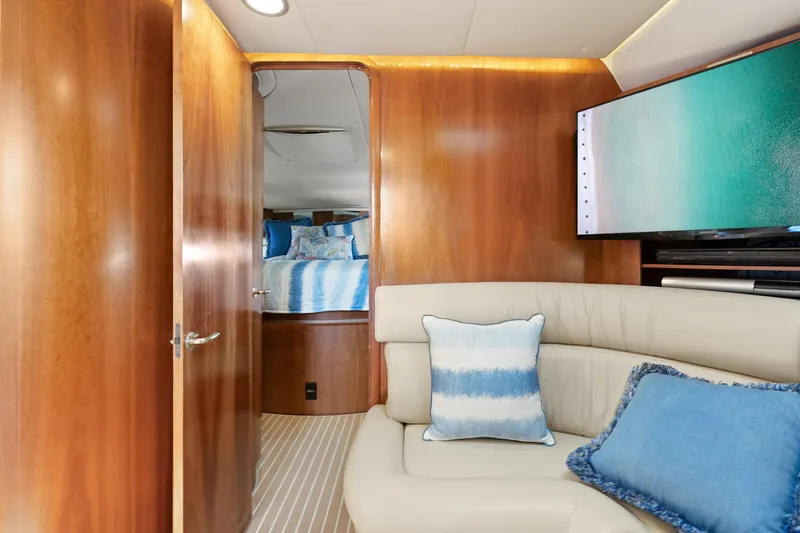 Cerulean Yacht Photos Pics Interior of 2000 Tiara Yachts 52 Express Cruiser with cozy seating and wooden paneling.