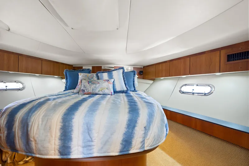 Cerulean Yacht Photos Pics Luxurious bedroom interior of 2000 Tiara Yachts 52 Express Cruiser with striped bedding.
