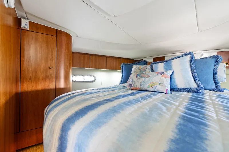 Cerulean Yacht Photos Pics Luxurious bedroom interior of 2000 Tiara Yachts 52 Express Cruiser with blue bedding.