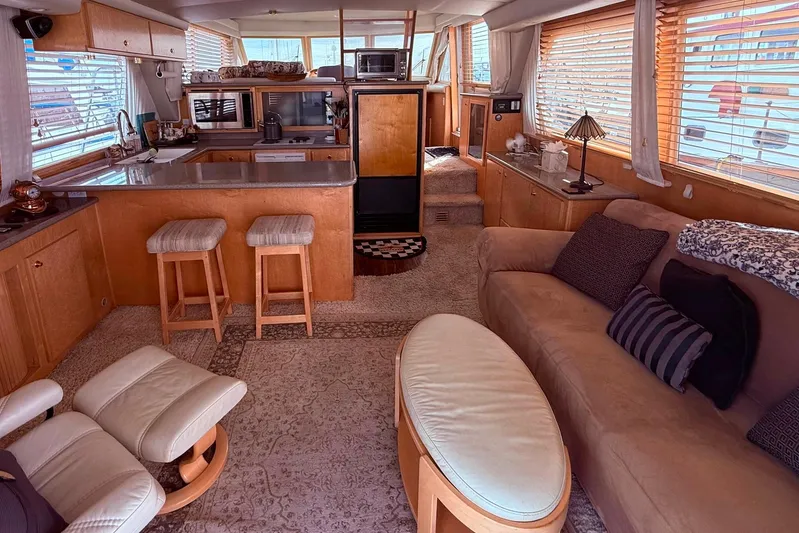 Gabbiano Yacht Photos Pics Luxurious interior of a 2000 Navigator 53 yacht with cozy seating and modern kitchen amenities.