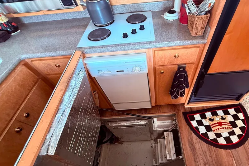 Gabbiano Yacht Photos Pics Compact kitchen in a 2000 Navigator 53 yacht with hidden storage access.