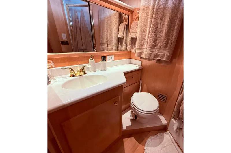 Gabbiano Yacht Photos Pics Luxurious bathroom in 2000 Navigator 53 yacht with elegant fixtures and plush towels.