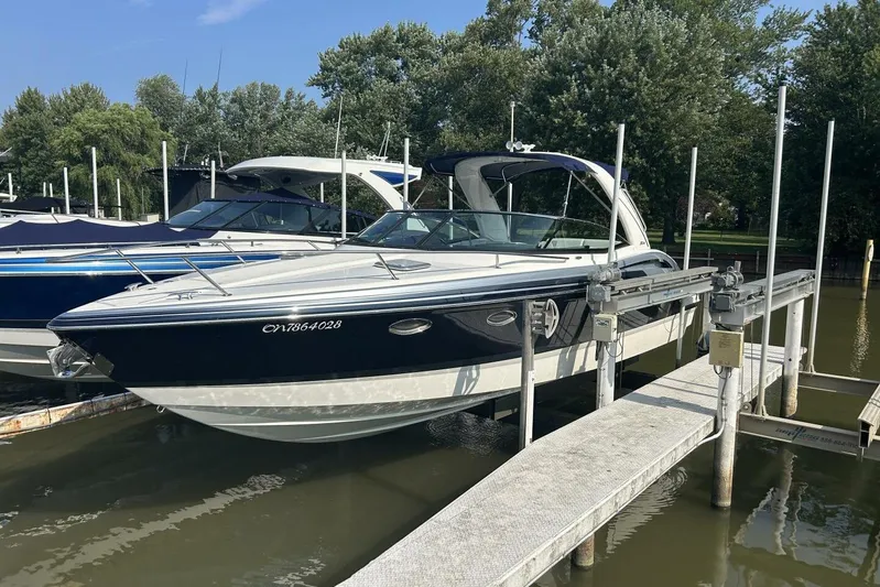  Yacht Photos Pics 2020 Formula 310SS boat docked at marina, surrounded by trees and water.