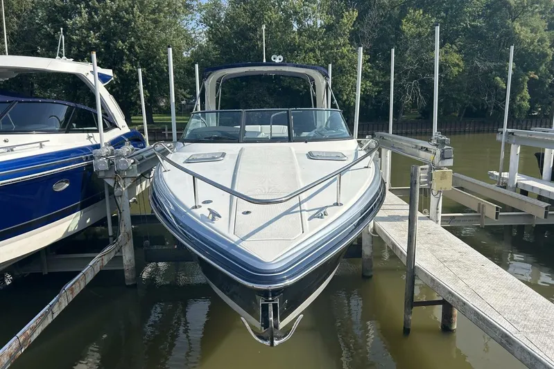  Yacht Photos Pics 2020 Formula 310SS boat docked, front view, surrounded by trees and water.