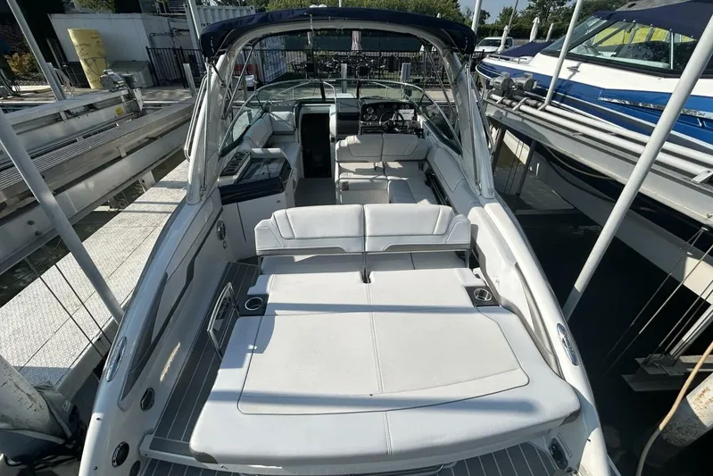  Yacht Photos Pics 2020 Formula 310SS boat with spacious seating and sleek design at a marina.