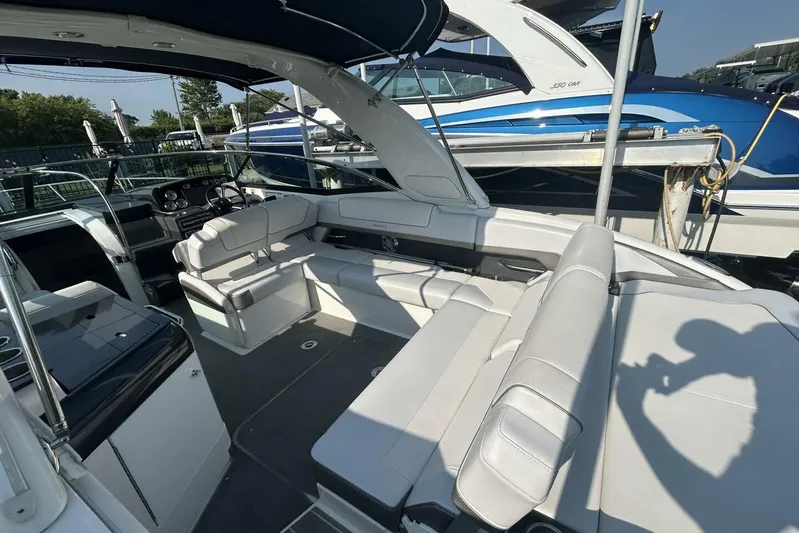  Yacht Photos Pics 2020 Formula 310SS boat interior with white seating and modern dashboard.