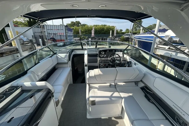  Yacht Photos Pics 2020 Formula 310SS boat interior with white seating and modern dashboard.